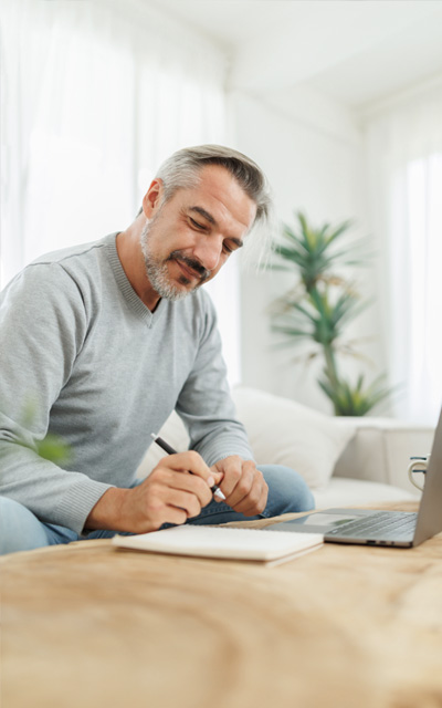 A man is taking notes from a meeting transcript